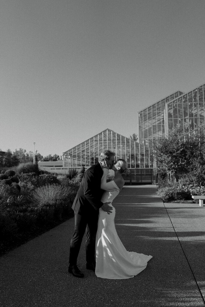 Wedding party group photo in lush gardens at Fredrick Meijer Gardens Grand Rapids Michigan