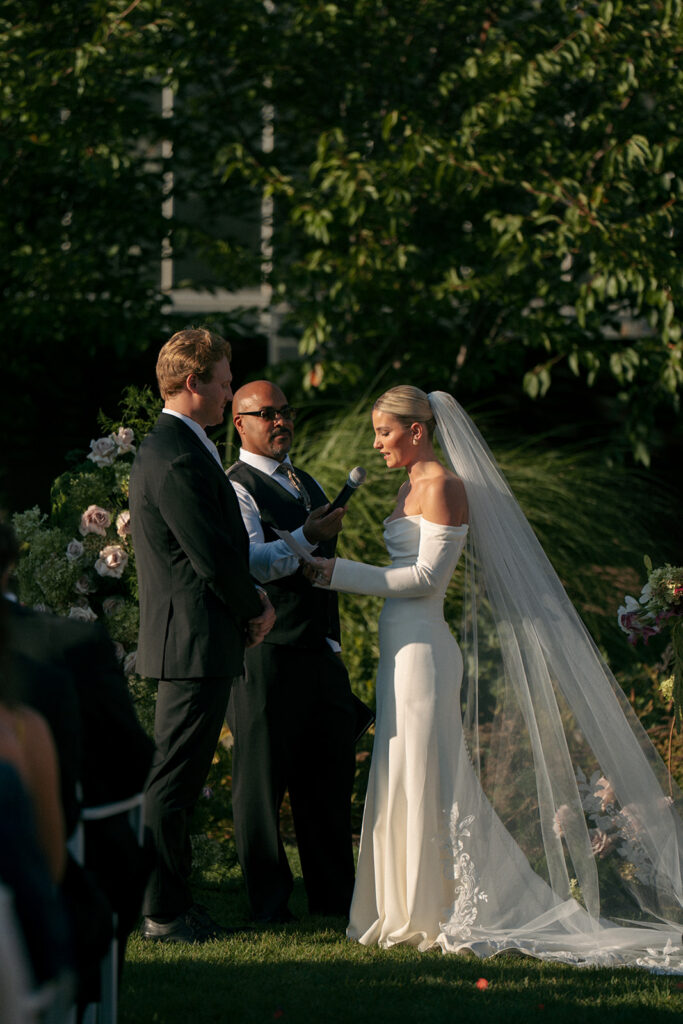 Wedding ceremony setup with white chairs and floral arch at Fredrick Meijer Gardens Grand Rapids