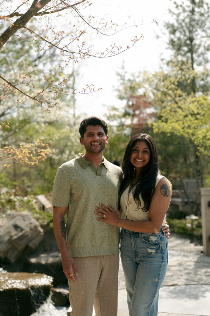Couple laughing together during engagement photos at Meijer Gardens Michigan
