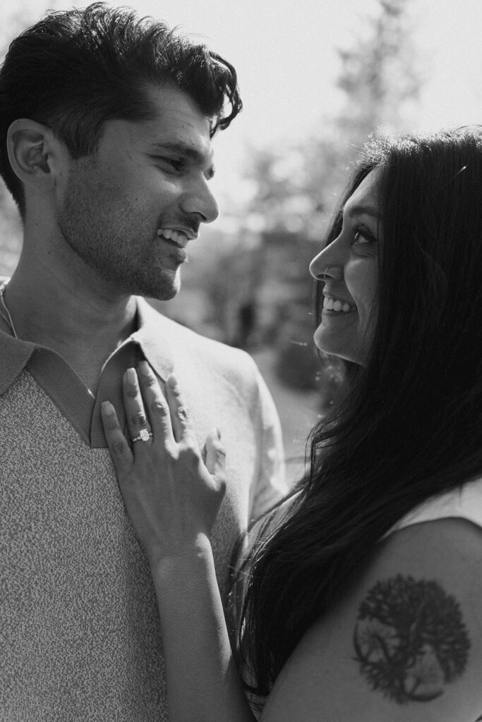 Engaged couple embracing among tropical plants at Frederik Meijer Gardens Grand Rapids