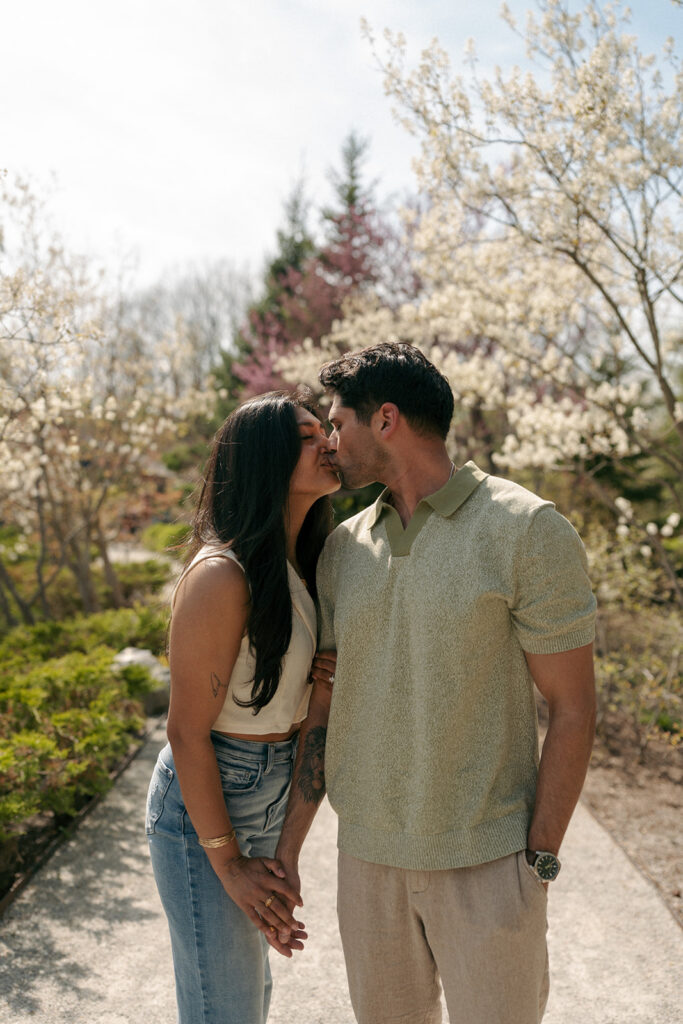 Couple embracing near water feature at Meijer Gardens Grand Rapids engagement photos