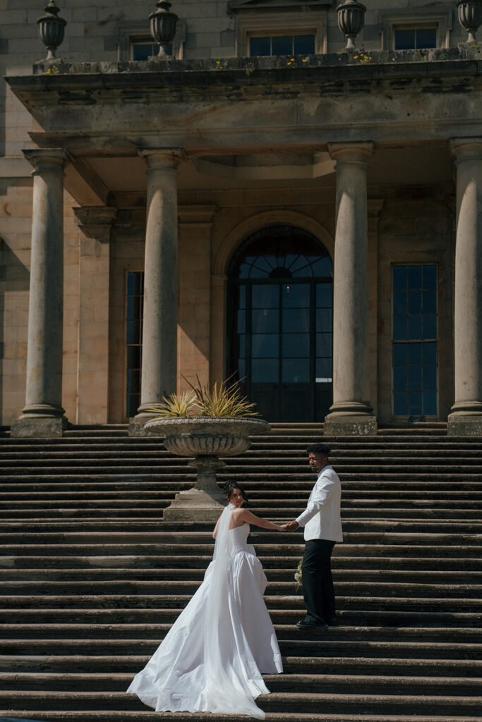 Bride and groom walking through historic Gosford House gardens Scotland