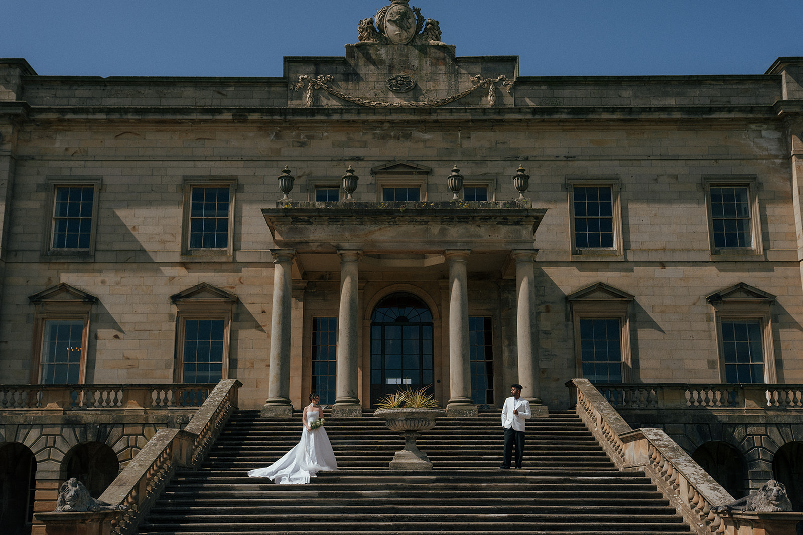 Groom in traditional Scottish attire standing in Gosford House estate grounds