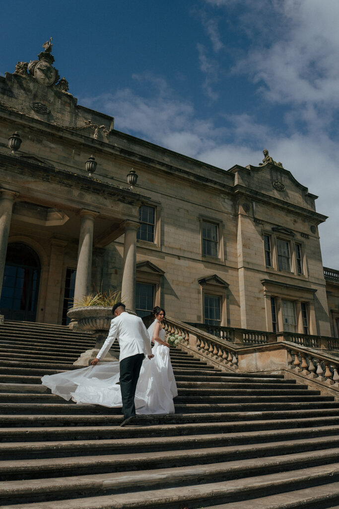 Bride and groom first dance under chandelier in Gosford House ballroom