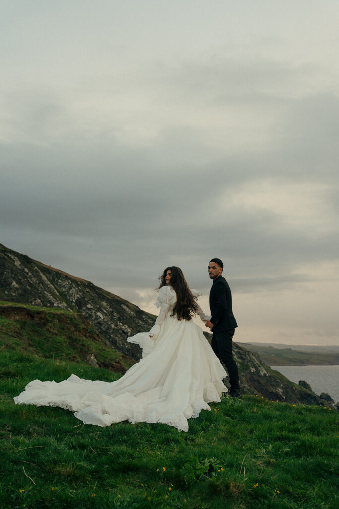 Couple laughing together during cliffs elopement photos Fast Castle Edinburgh Scotland candid moment