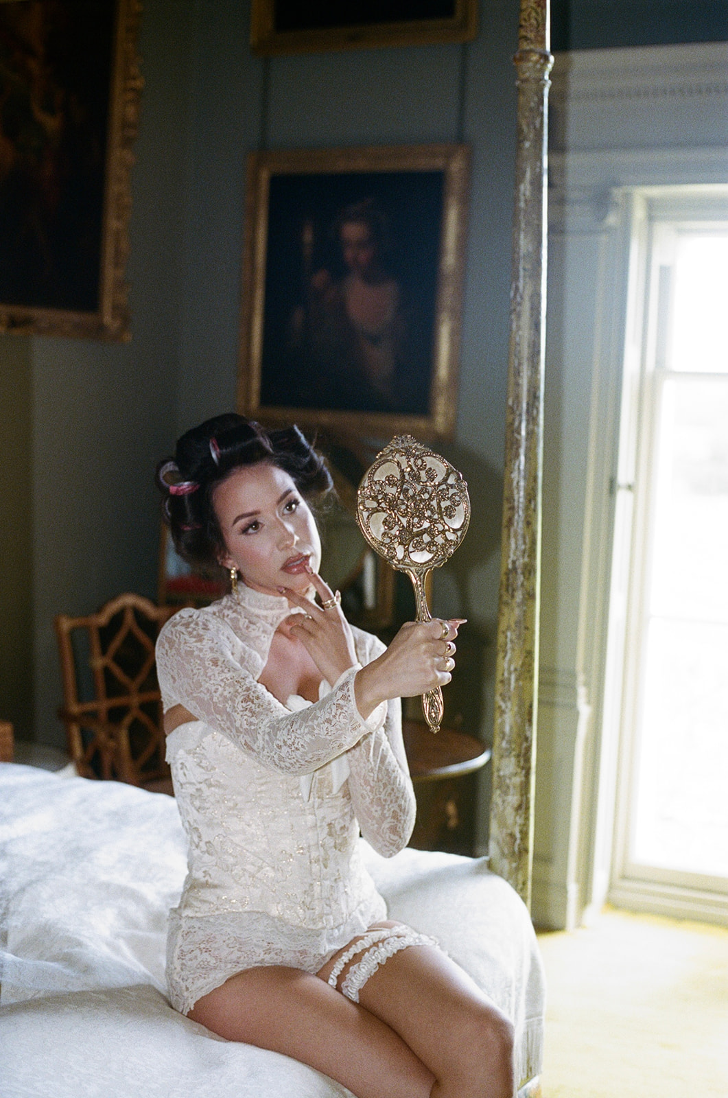 Bride in white robe holding champagne flute in bright editorial getting ready photo at Gosford House Scotland