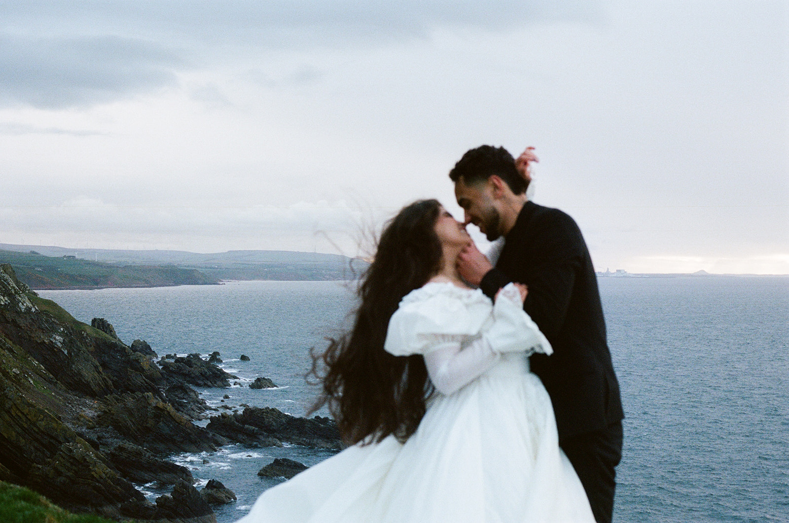 Full length portrait of couple during cliffs elopement photos Fast Castle Edinburgh Scotland landscape